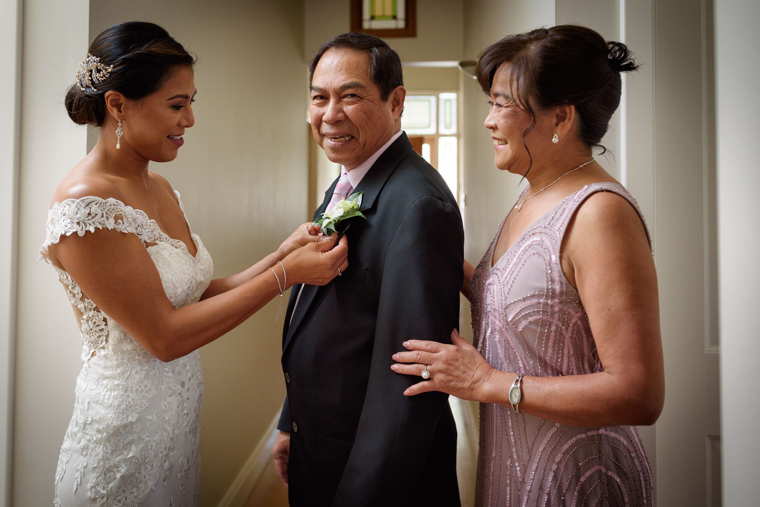 Bride pinning flower on fathers lapel with her mother - Kelly Chapman Photographer Perth