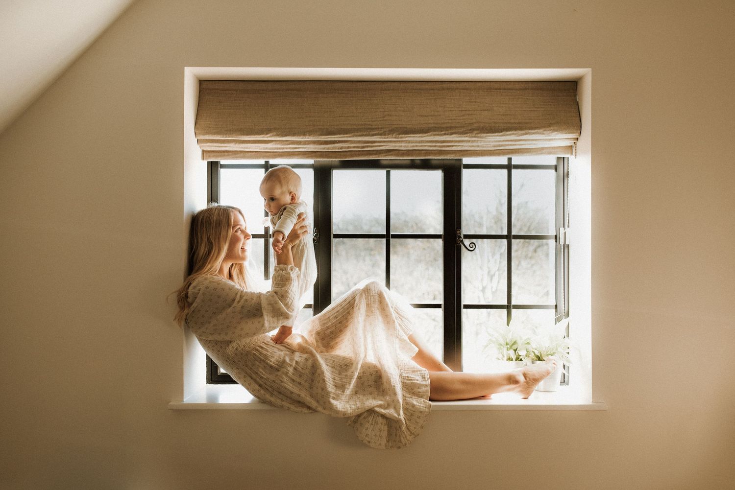 mother and baby in beautiful  home photo shoot, with dazzling natural light
