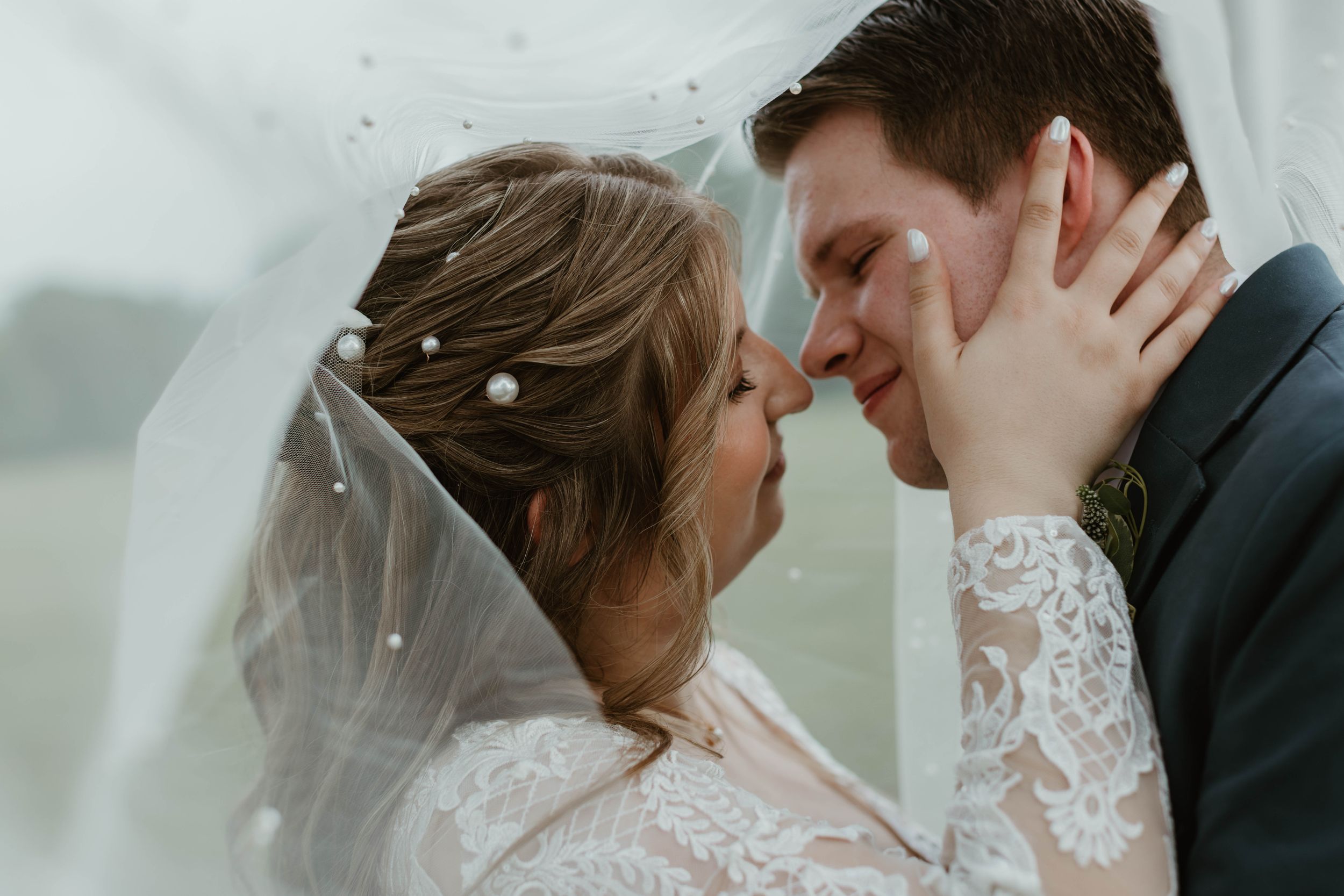 An intimate wedding photo session with a couple in formal attire indoors.
