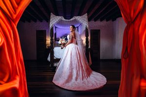 A wedding dress photoshoot sequence showing a flowing white gown against dramatic red curtain backdrops.