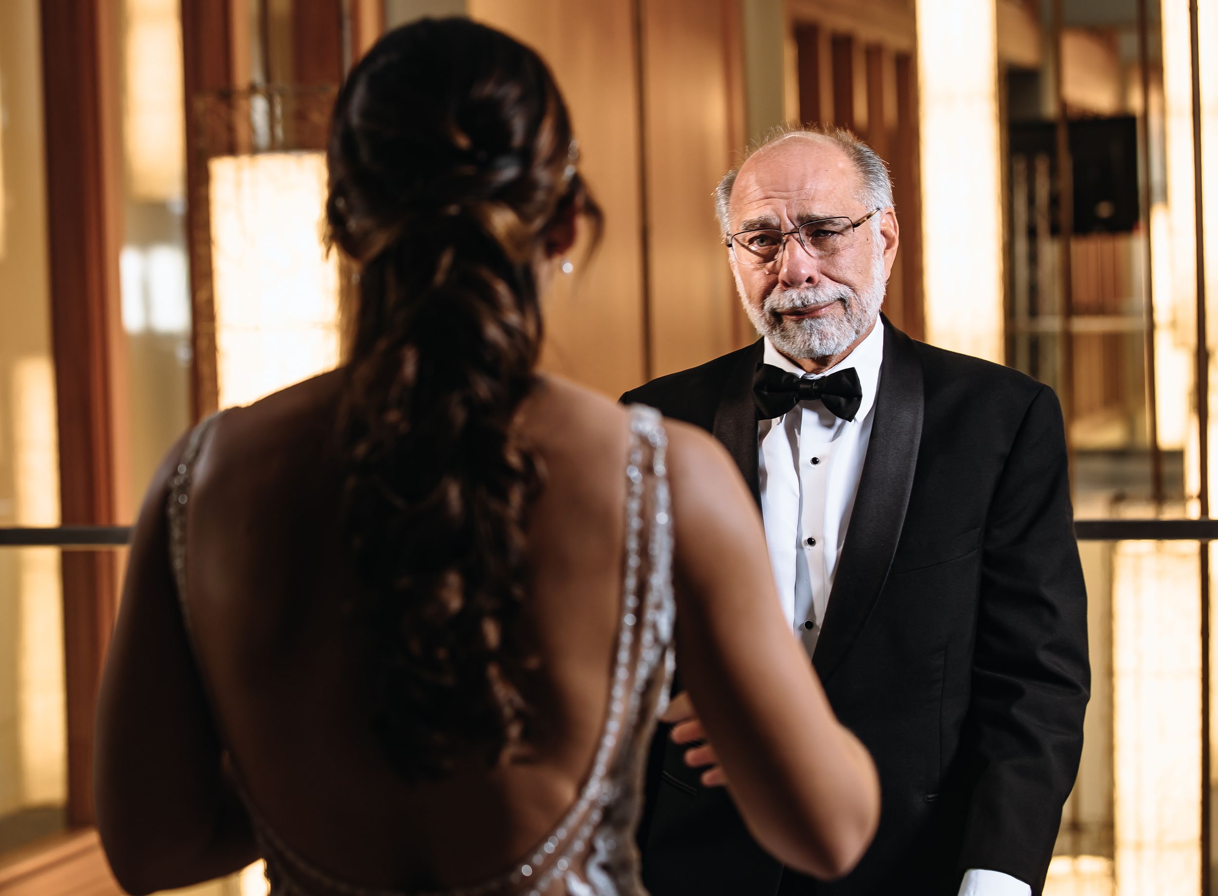 Formal moment shared between the bride and her father in her wedding day