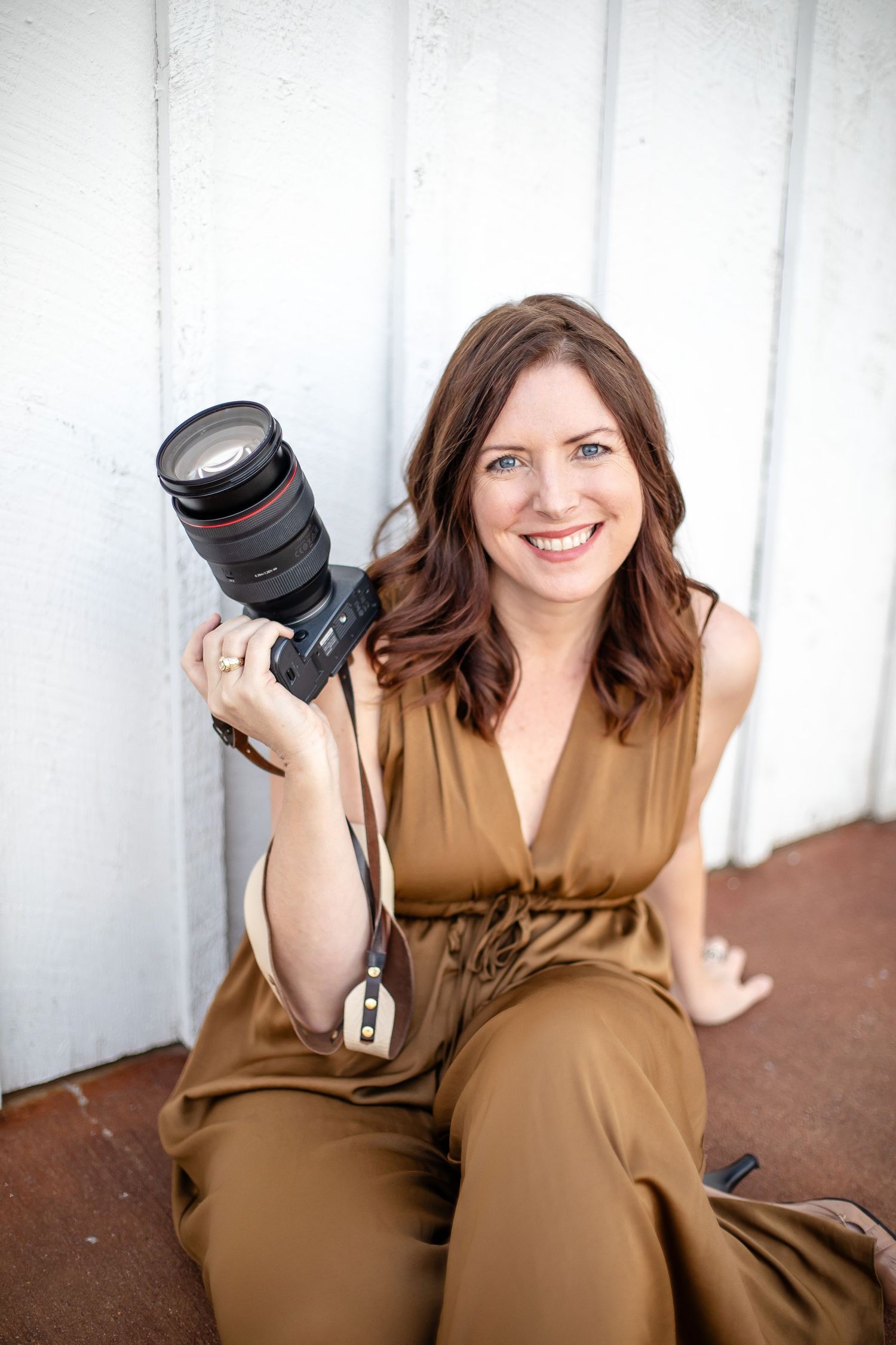 photographer Brandy Gray holds her Canon camera she uses for every wedding in Texas