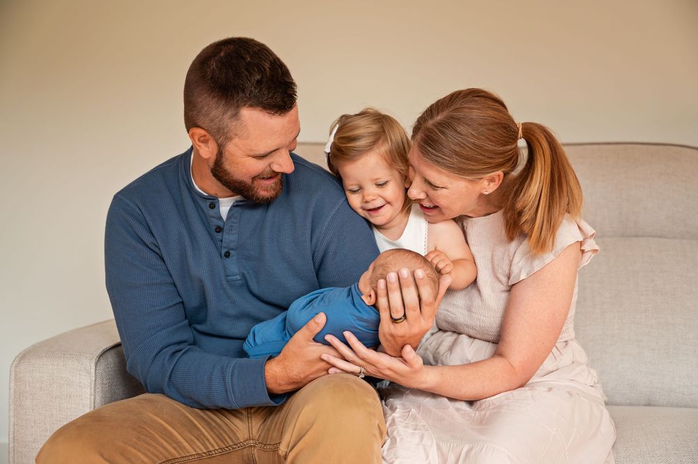 A series of tender family moments captured on a beige couch showing affectionate interactions between parents and child.