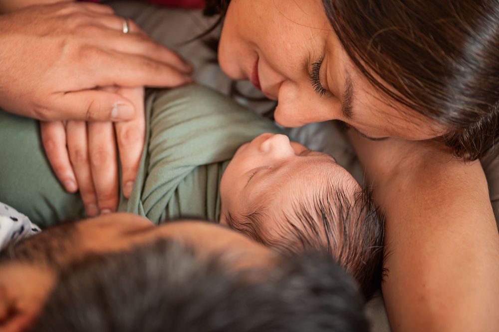 Close-up photo series showing tender moments between parent and newborn baby in soft, warm lighting.
