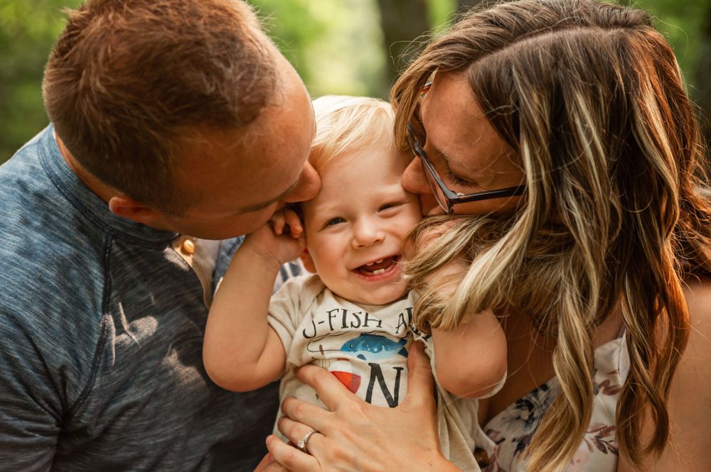 Family sharing an intimate moment of joy and laughter together outdoors.