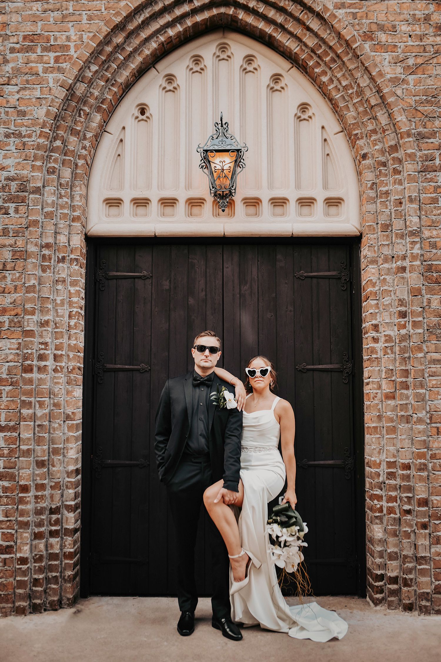 Bride and groom standing together in a hip pose