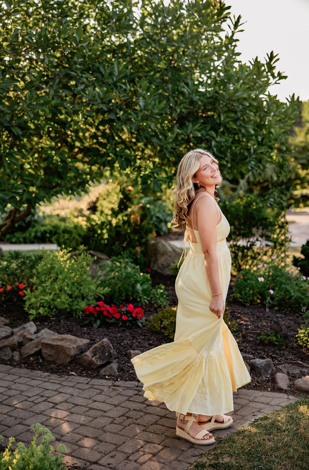 Teen girl senior photoshoot outdoors with yellow dress in Rochester, New York.