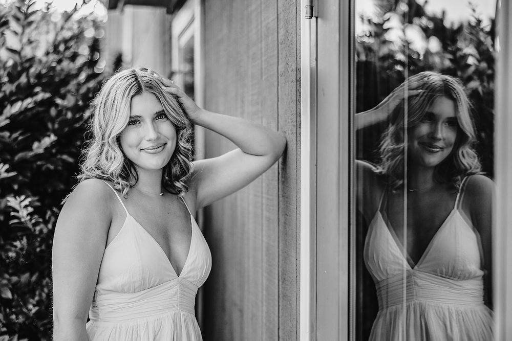 High school senior girl posing for professional senior portraits in Rochester, NY. Black and white portrait.