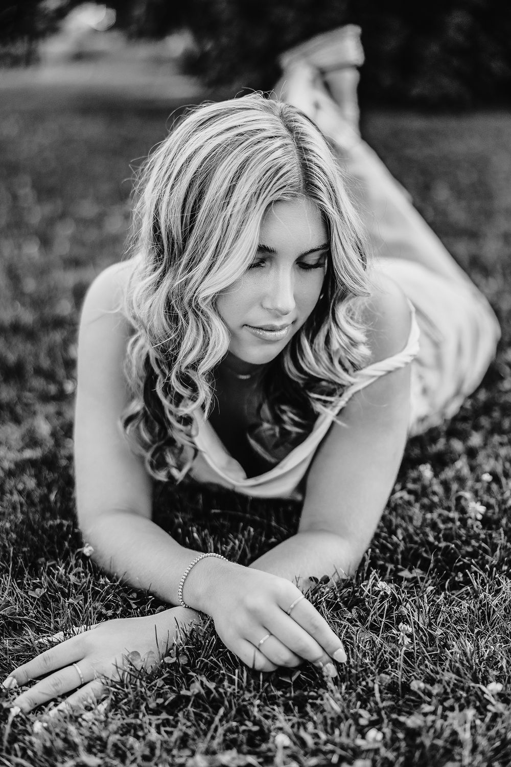 Senior girl posing outdoors for professional portraits in Rochester, NY. Black and white picture.