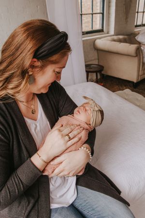 Tender moments between parents and their newborn baby in a bright, airy room.