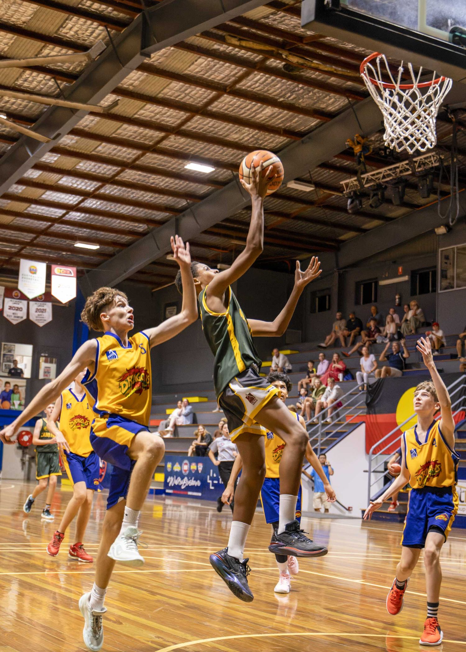 Image by Nick Wigmore Photography: Lang Park Basketball, young men playing basketball indoors.