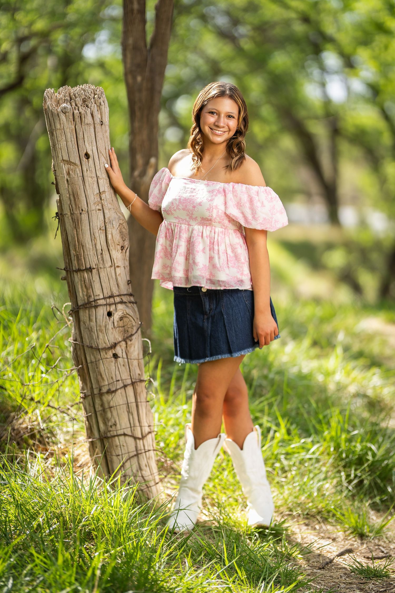 A series of outdoor portraits showing someone in a pink ruffled top and denim shorts against a natural wooded backdrop.