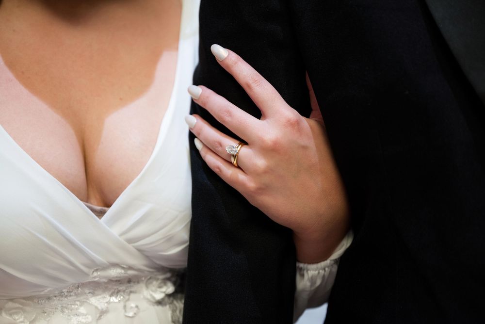 Detail shots focusing on white wedding dress and formal attire.