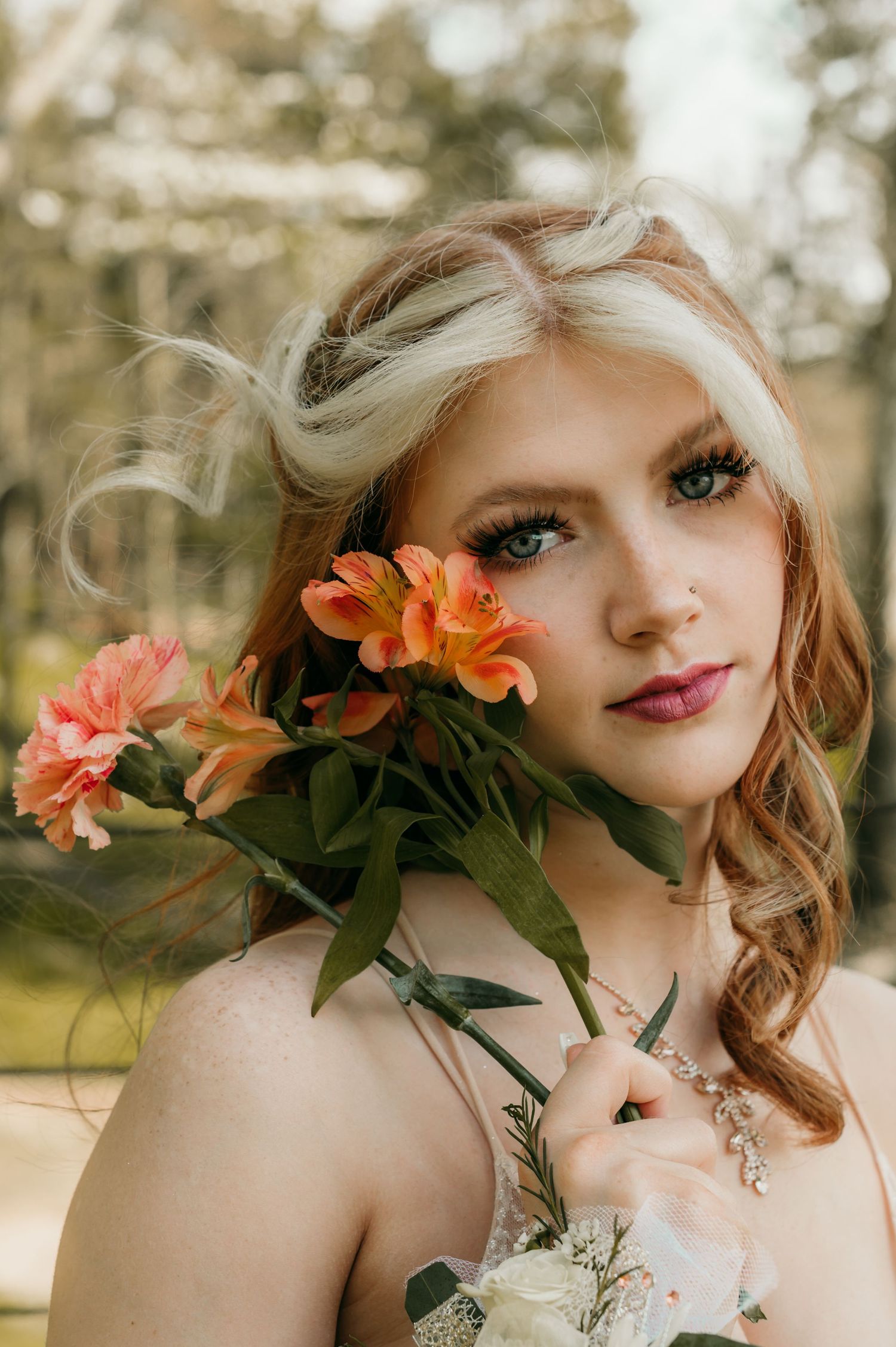 Portrait with orange lilies and soft bokeh background in natural lighting.