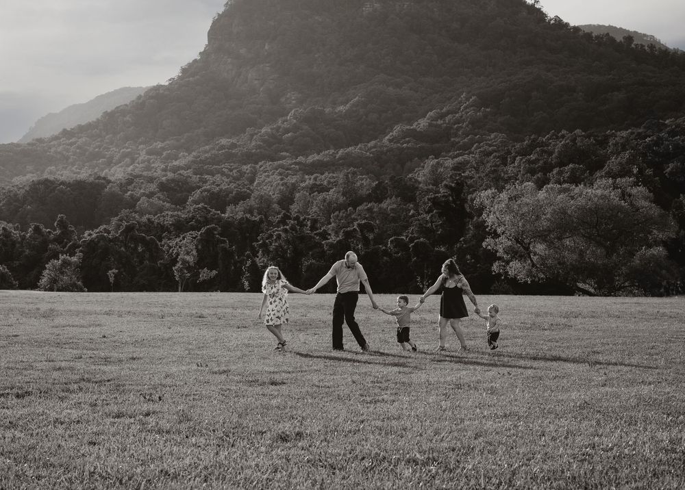Family enjoying summer portrait session at Moses Cone Park, Lake Lure, NC.