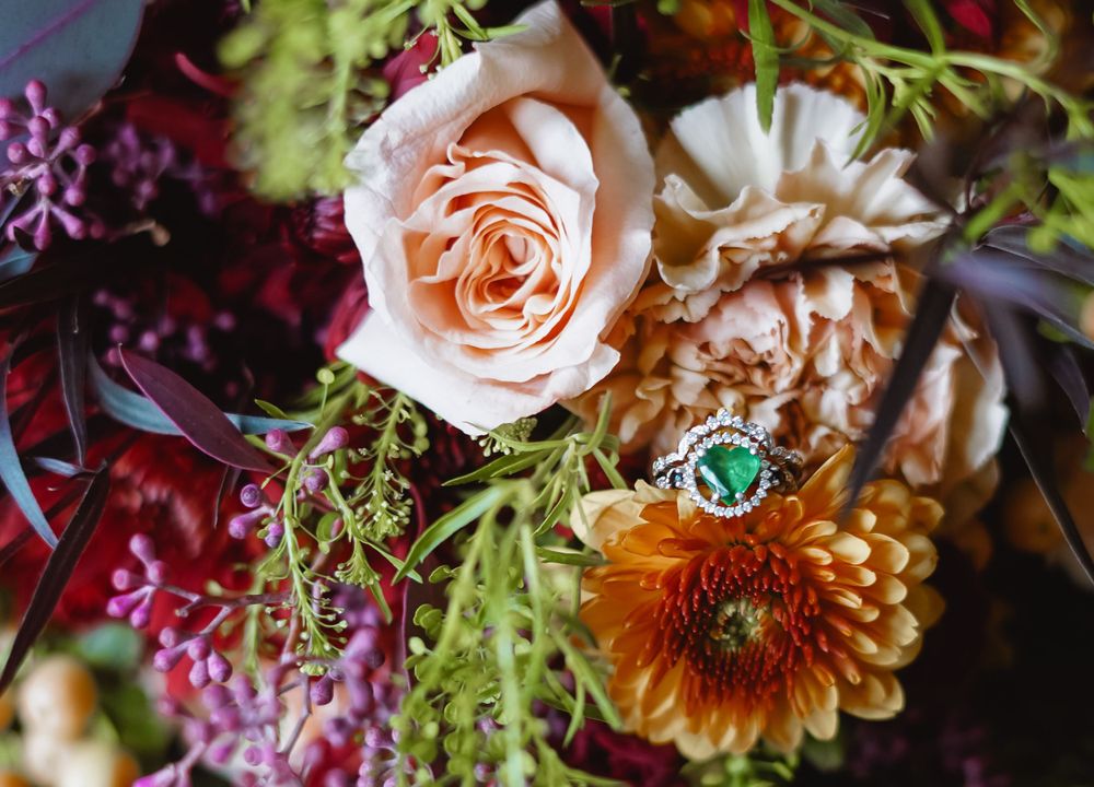 Close-up of vibrant wedding bouquet featuring roses and mixed seasonal flowers.