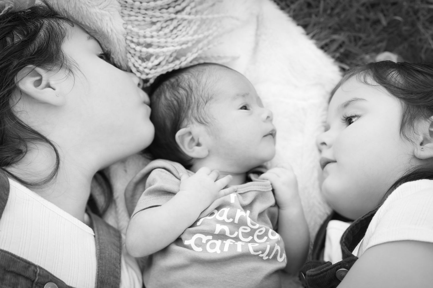 sister baby boy newborn session extended family candid black and white