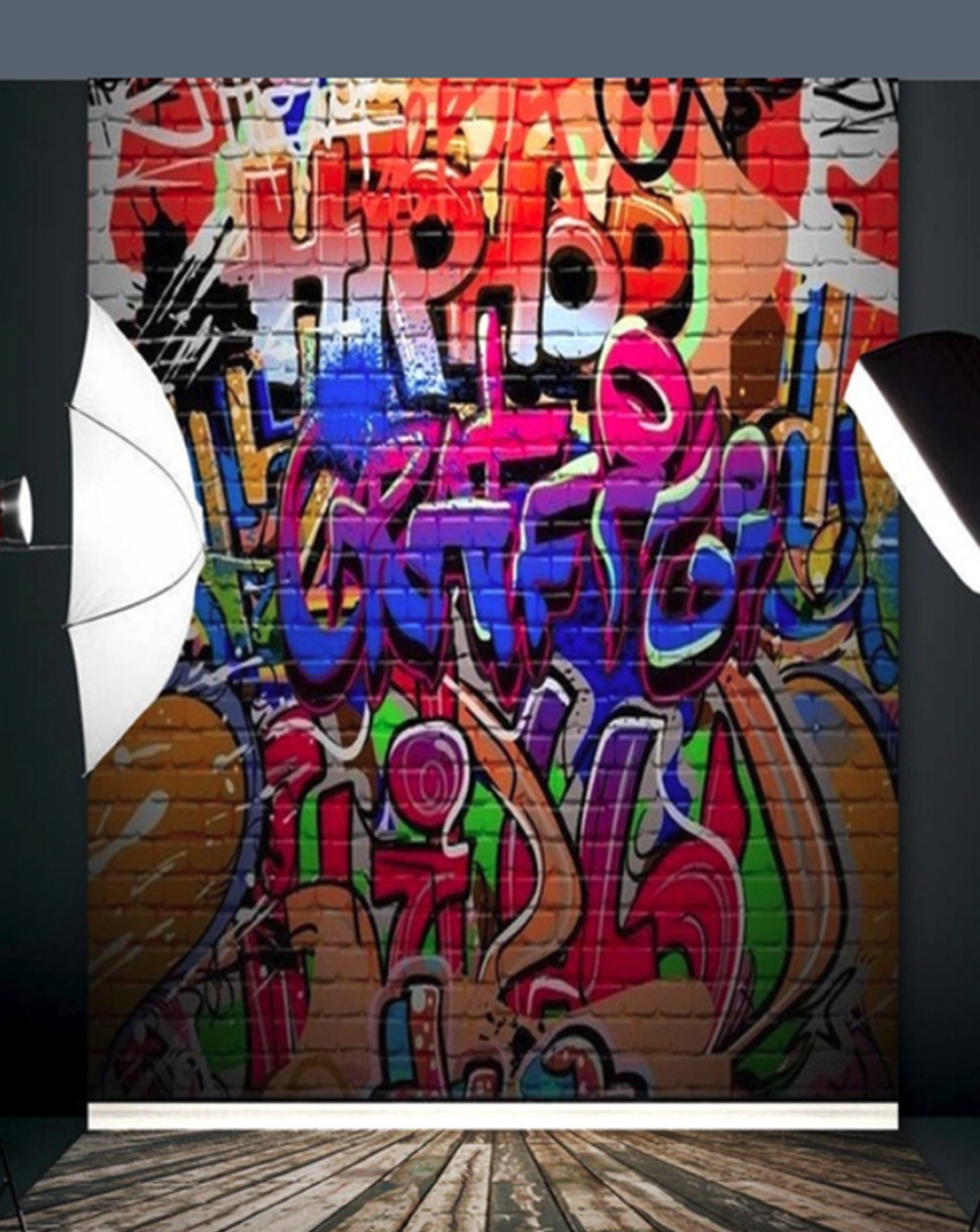 Colorful graffiti art backdrop on brick wall displayed in a photography studio setup with lighting equipment.