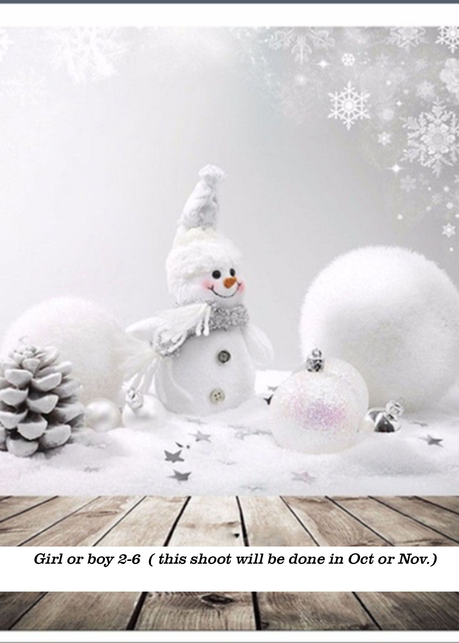 White snowman with carrot nose surrounded by silver ornaments, pine cone, and fluffy snow balls on wooden floor backdrop.