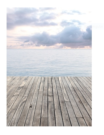 Weathered wooden dock overlooking a calm ocean with soft pastel clouds in a serene coastal landscape.