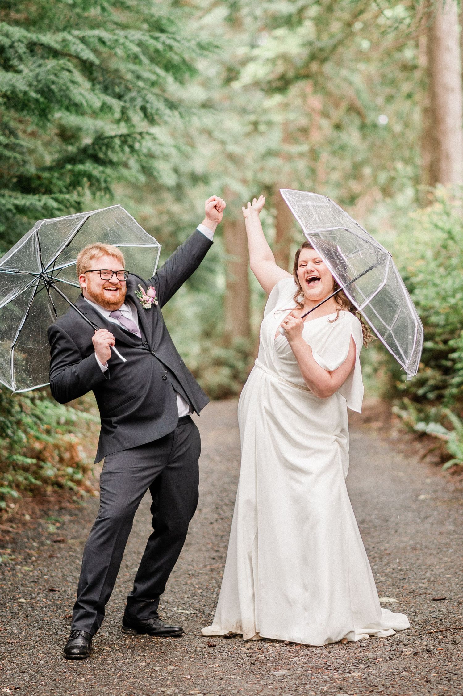 bride and groom dancing with umbrellas during rainy elopement on Harstine Island.