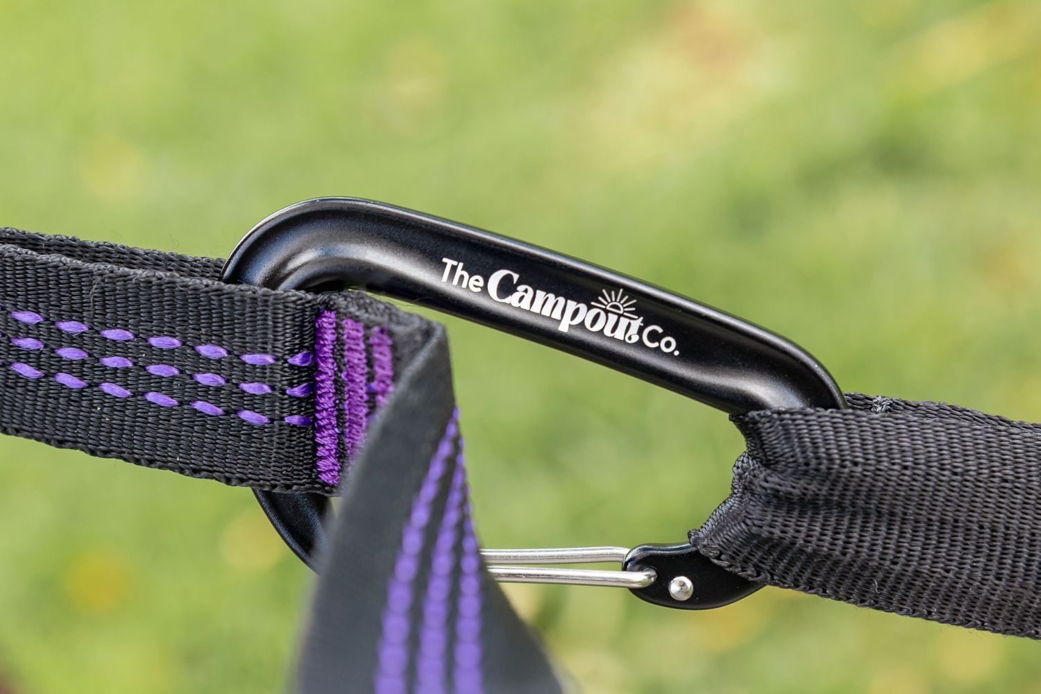 Close-up of purple and black hammock straps and hardware details.
