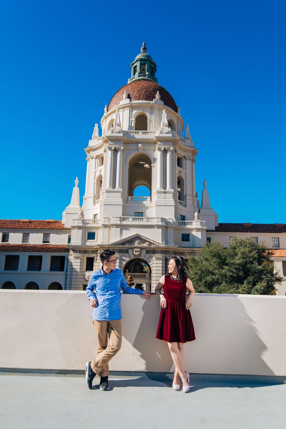 A couple poses in front of the iconic Pasadena City Hall dome.