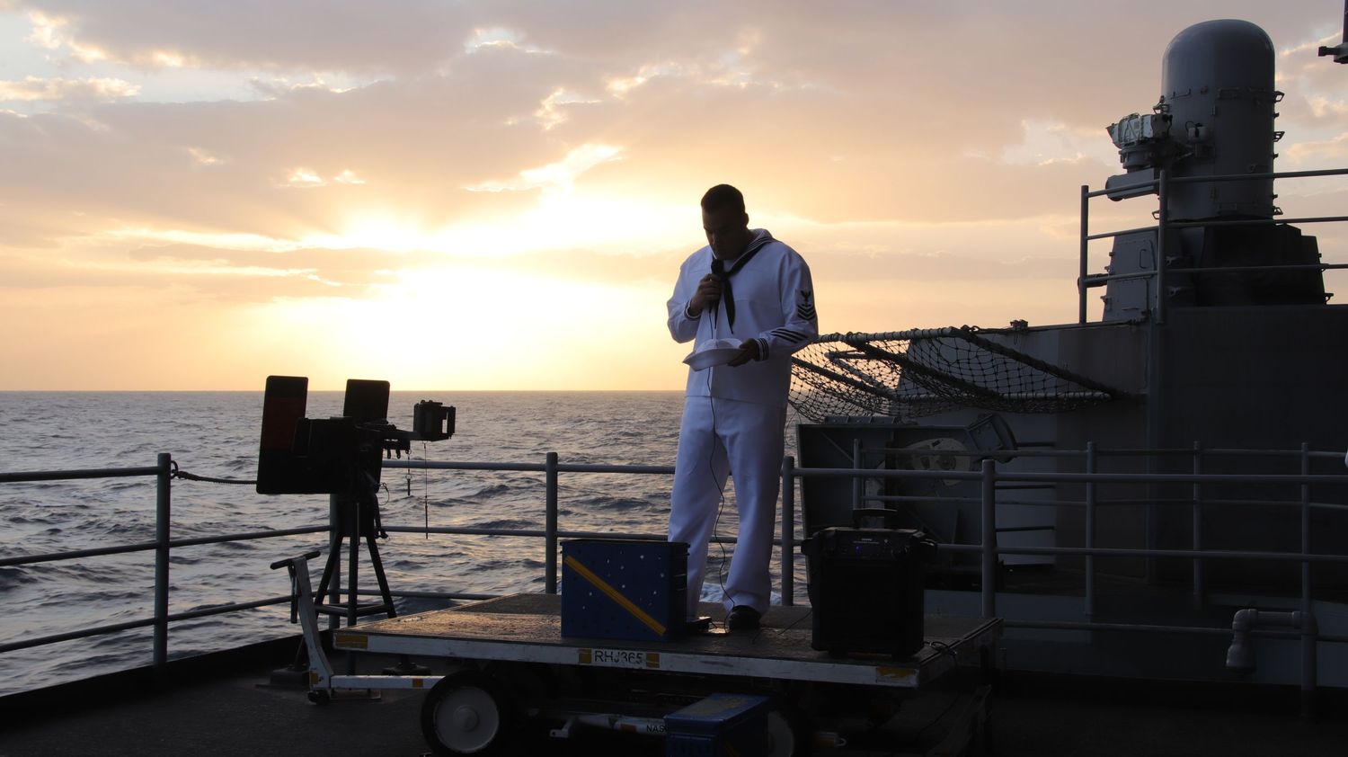 Portcall Productions deployment photography capturing the solemn atmosphere of an morning service at Sea aboard a U.S. Navy warship