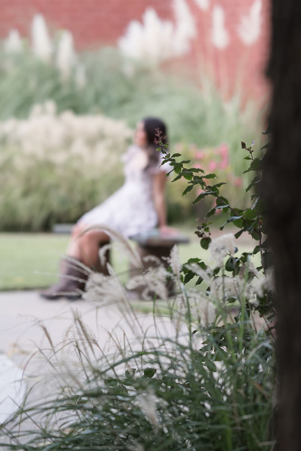 Artistic shallow focus shot of plants with blurred figures in the background.