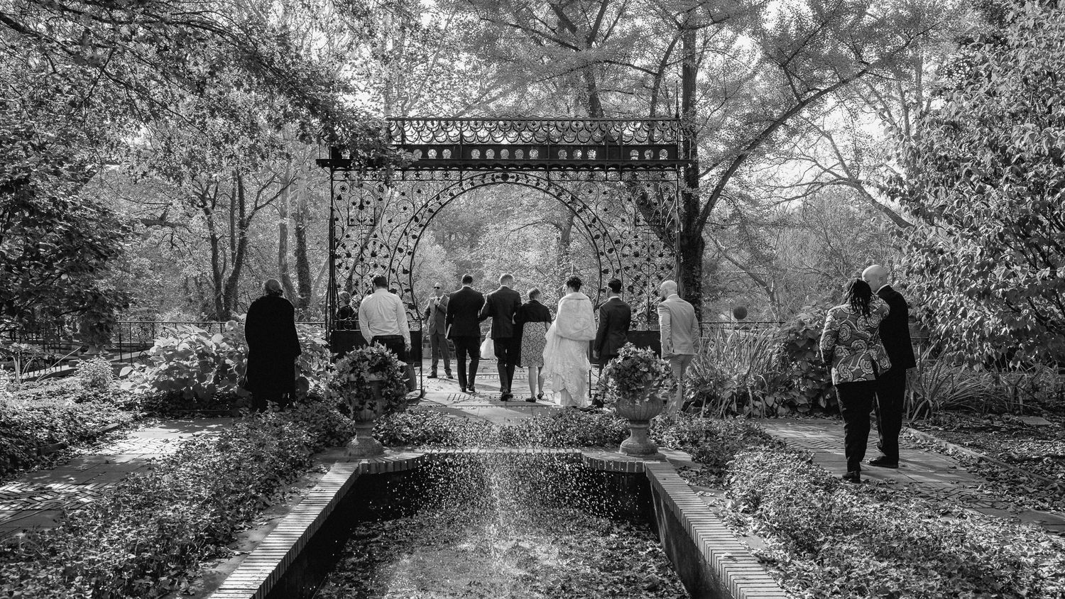 A black-and-white photograph of a garden ceremony at the Cleveland Cultural Gardens, shot by Swanky Bolt Studios.