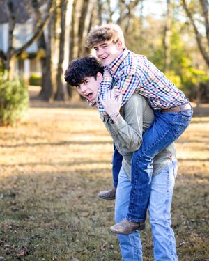 Playful piggyback ride moment captured in autumn backyard setting.