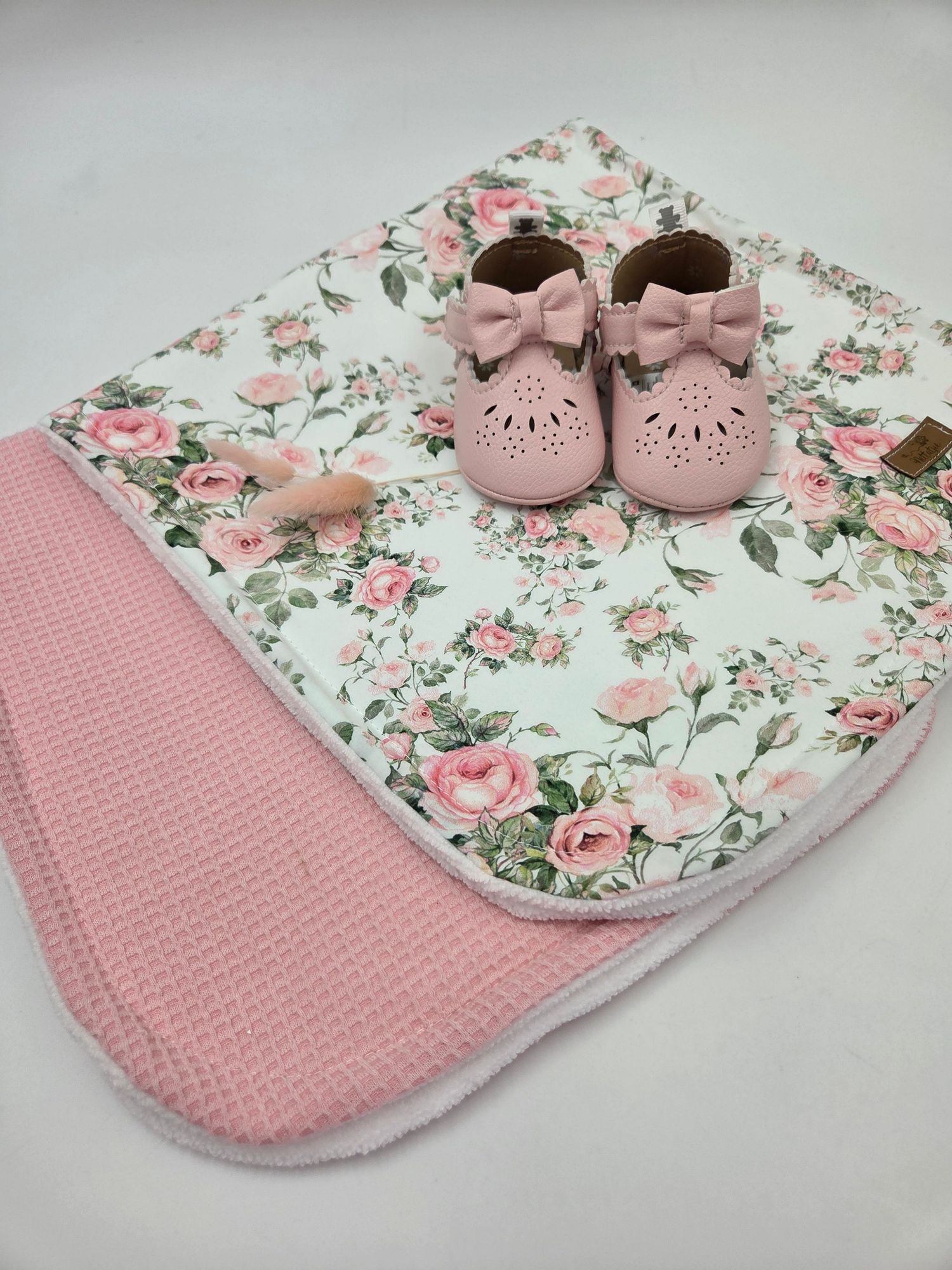 Vintage floral burp cloth with pink knit backing and matching baby shoes.