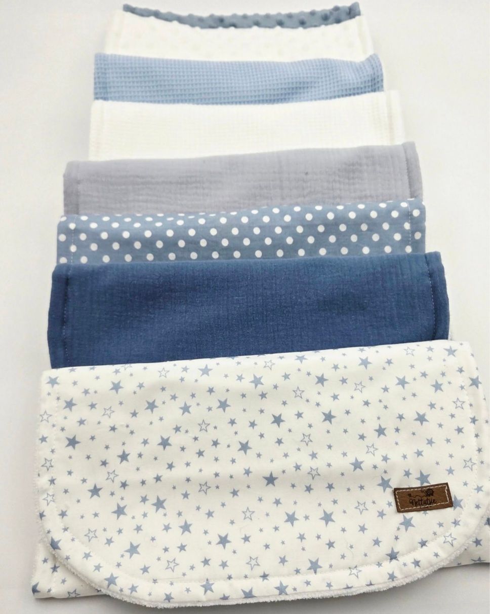 Set of blue and white baby blankets with star and polka dot patterns.