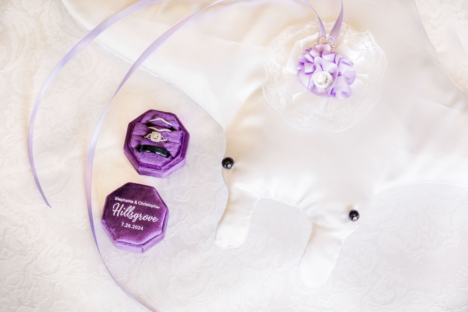 Purple wax seals and decorative ribbons on white fabric.
