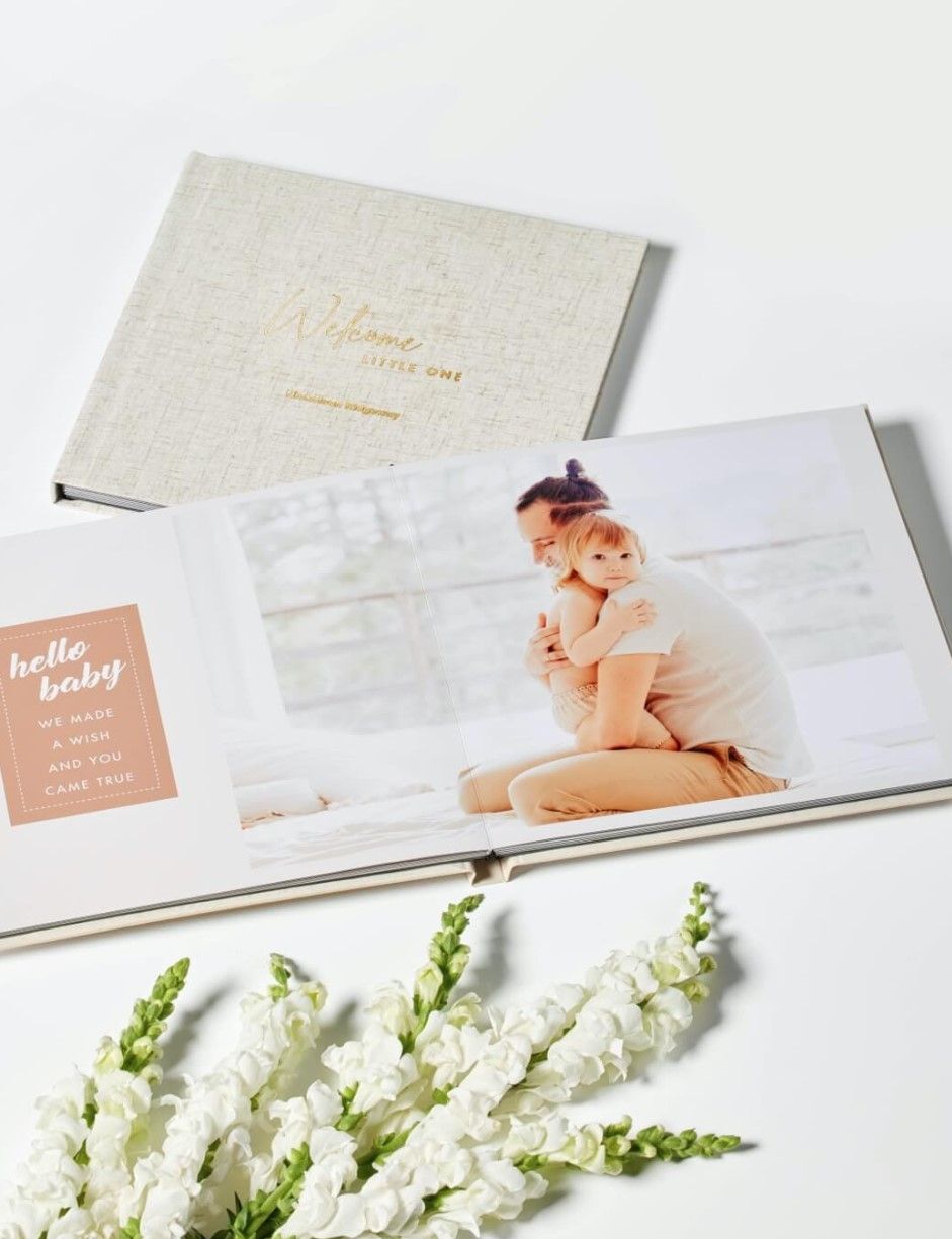 "Adorable customized photo album featuring baby's first year, with a soft pastel cover and personalized name