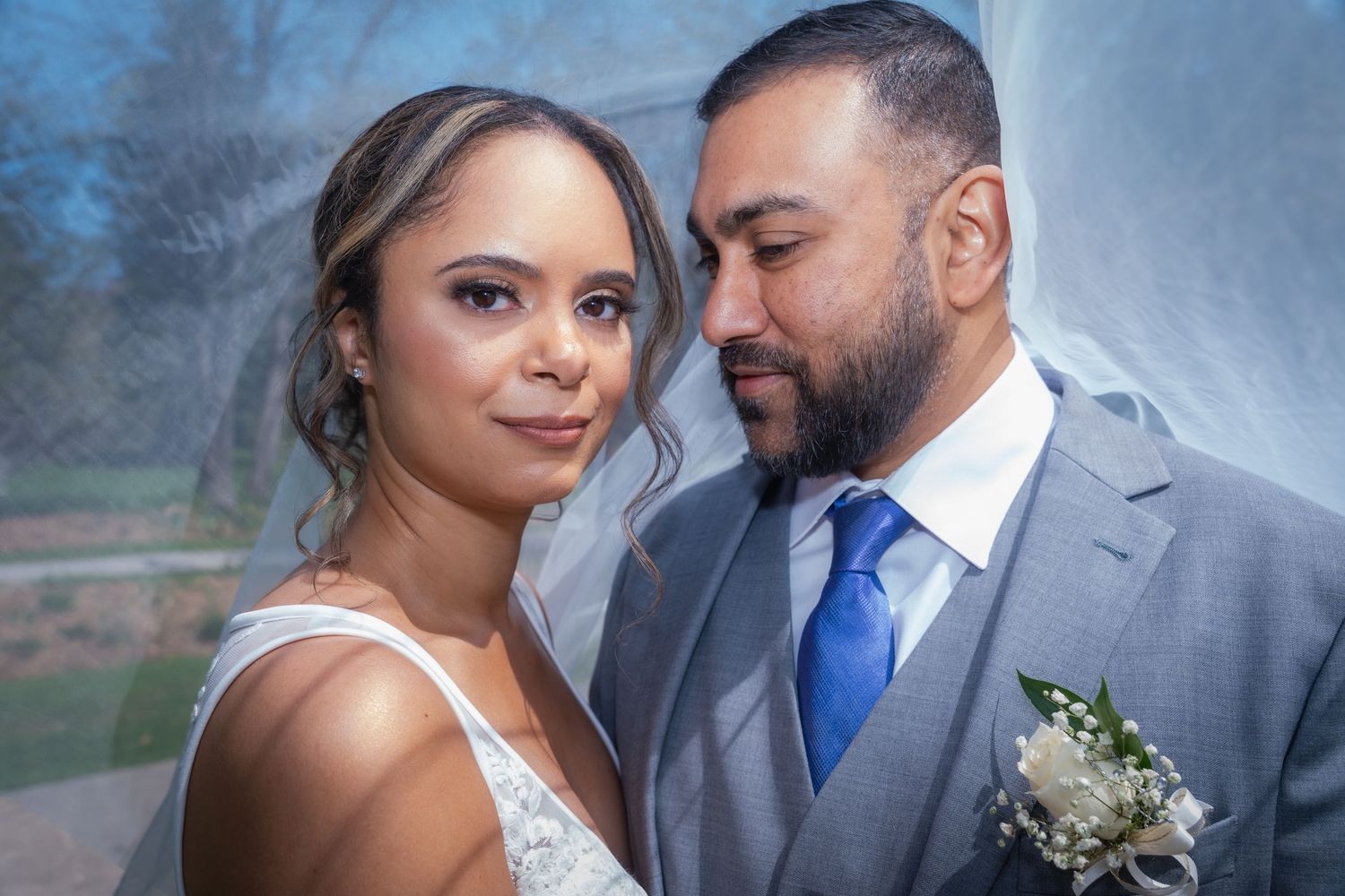 Artistic wedding portraits with soft lighting and intimate poses between newlyweds.