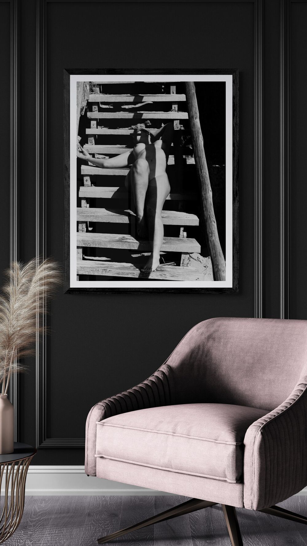 A modern gray living room features a dusty pink velvet armchair and black and white abstract architectural photograph.
