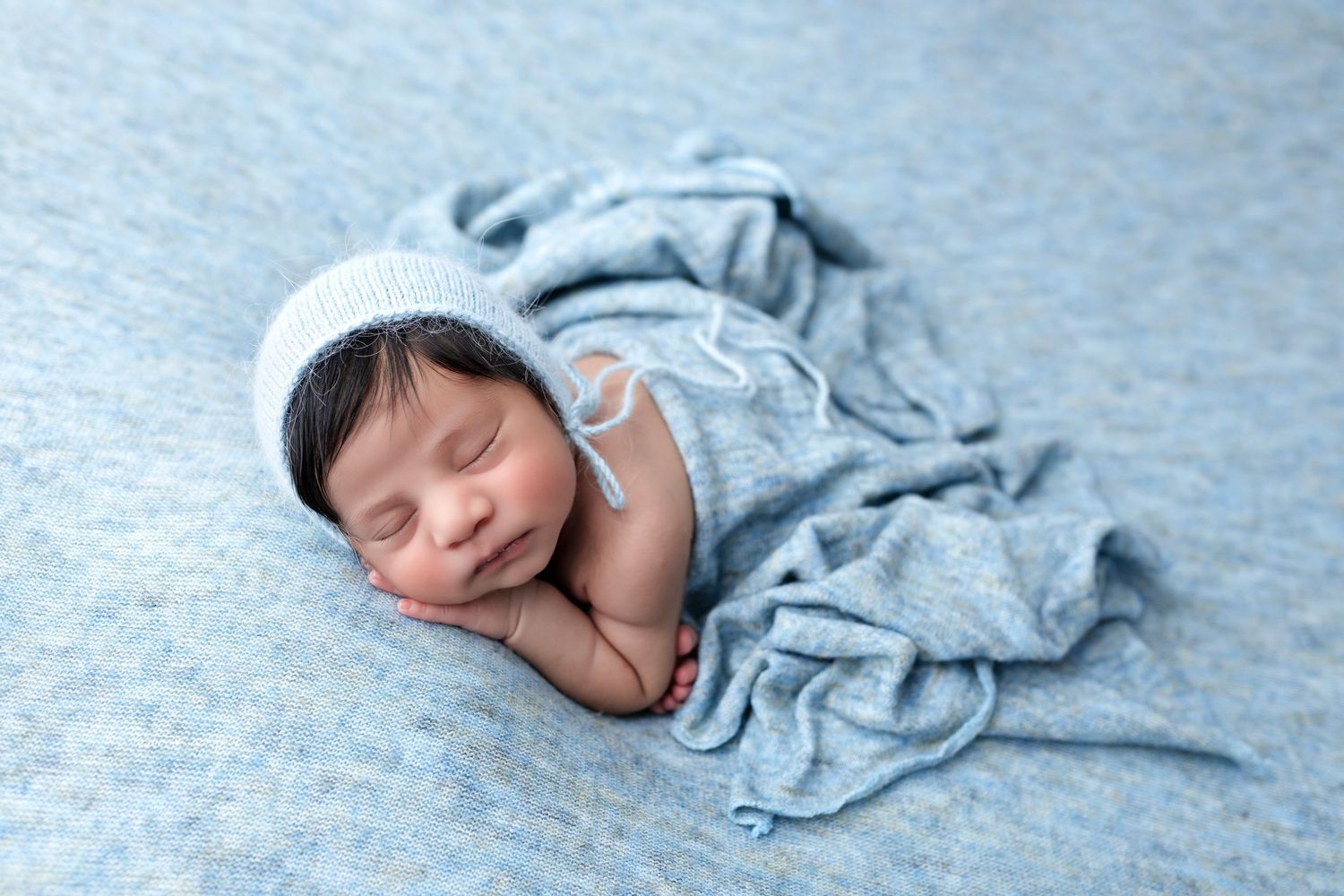 Newborn posed on the beanbag doing the bum up pose during the newborn session