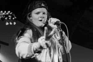 Dramatic black and white performance shots showing intense stage presence.