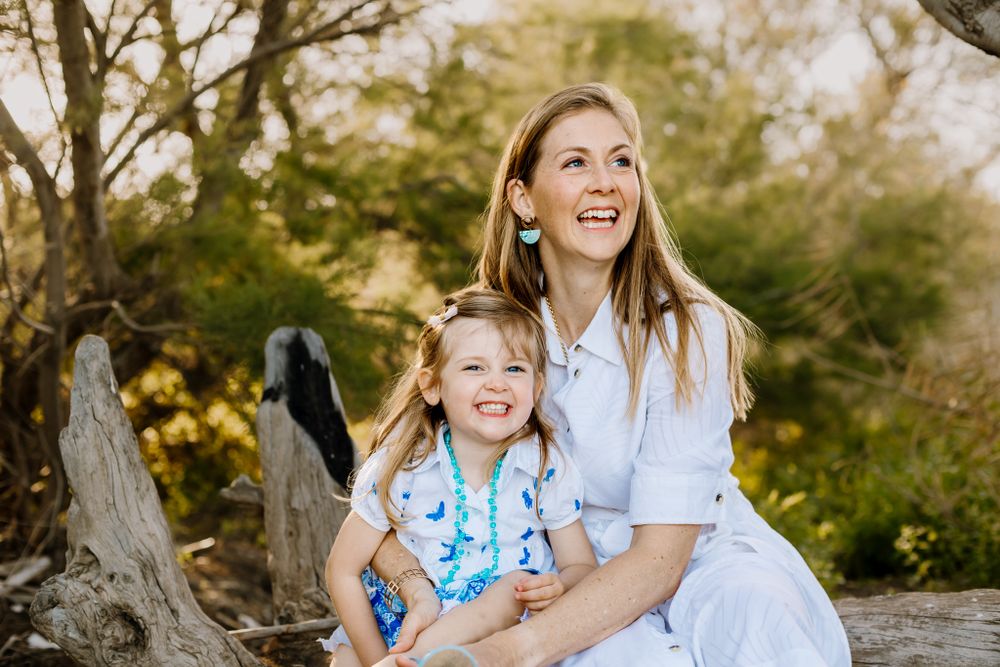 Sofia and her mother laughing in a moment of joy at family photo session in Malaga