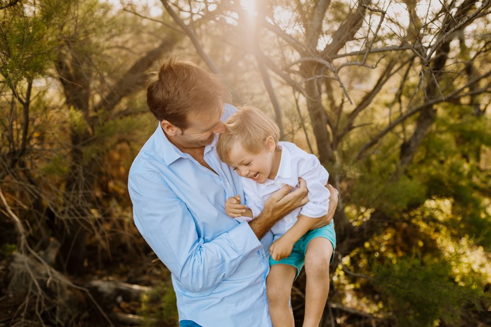The father tickles Rafa in a sweet moment during the spring photo session in Malaga.