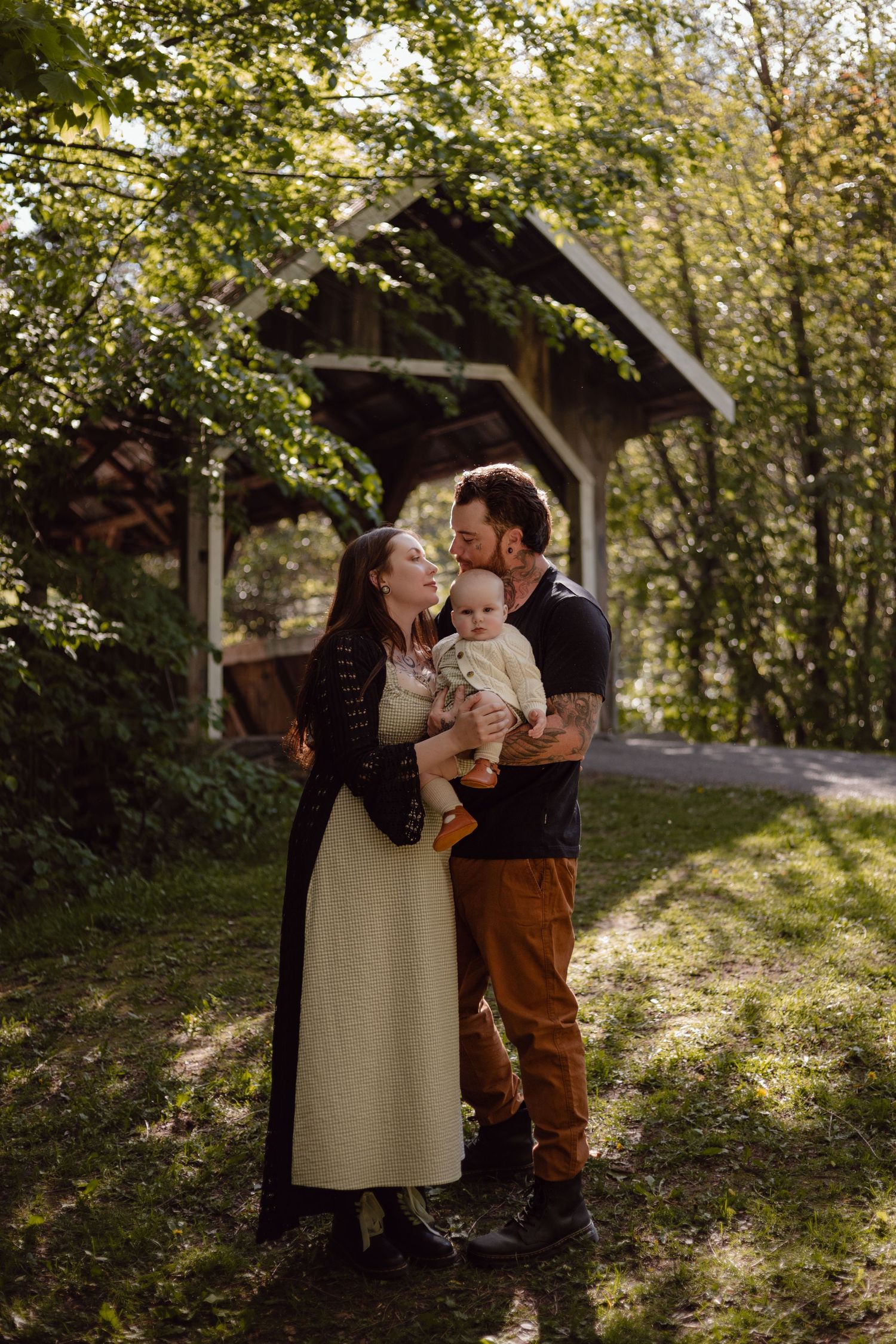 Couple snuggles up close surrounded by lush greenery at Badlands Ontario for their engagement photos.