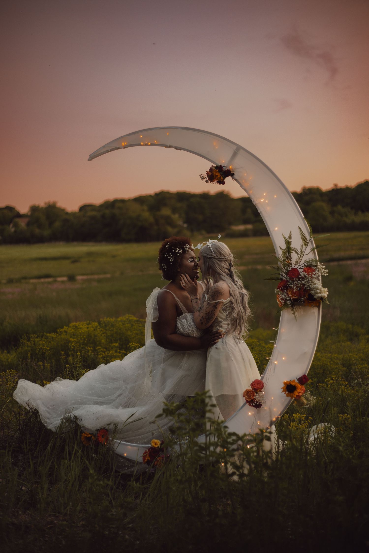 LGBTQ+ wedding photographer captures brides about to kiss during sun set.