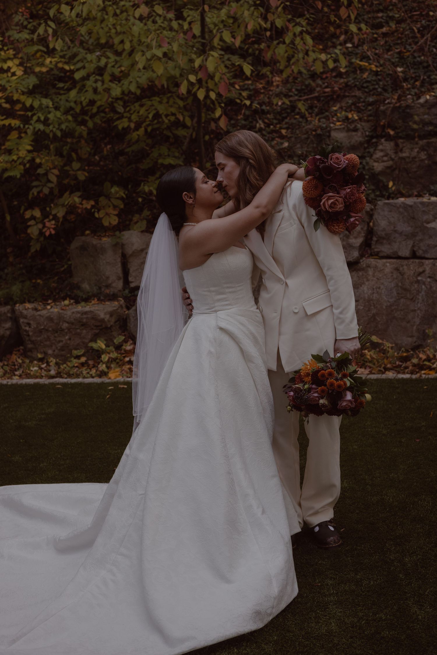 Brides posing for moody portraits at Ancaster Mill.