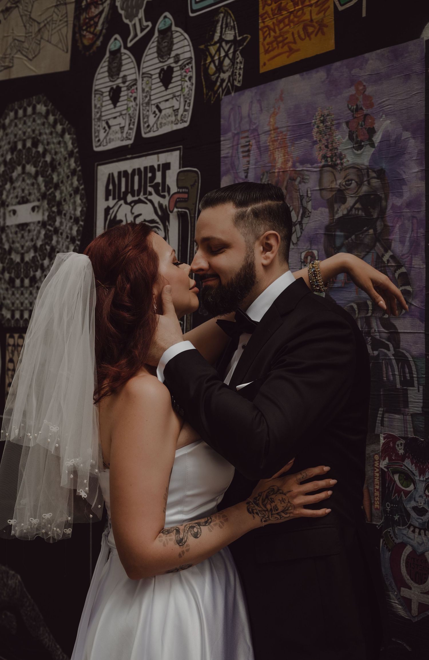 Bride and groom posing in an alley in Toronto full of graffiti.