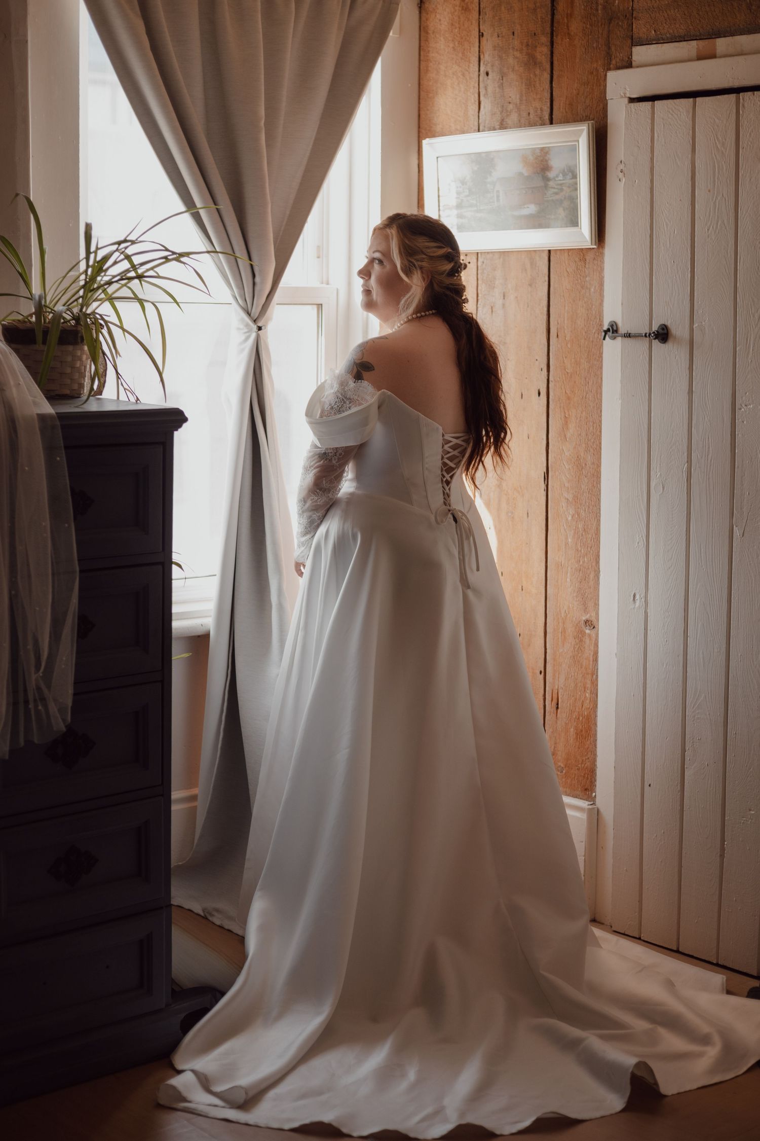 Bridal portrait in front of upstairs window. Taking a moment before the beautiful chaos of the wedding starts.