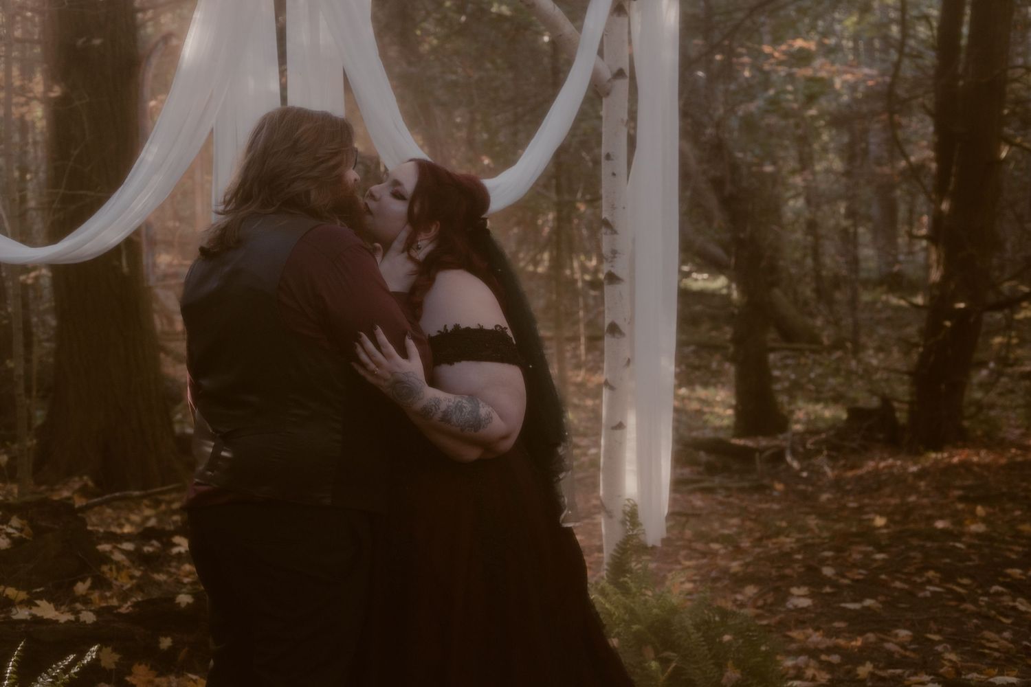 An ethereal portrait of the bride and groom sharing a kiss in the same spot they said their sacred vows.