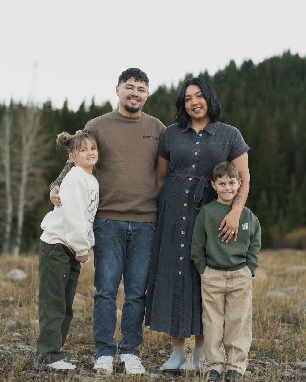 Family embracing in scenic Tony's Grove, Bear Lake, UT, during a photo session in Logan Canyon.