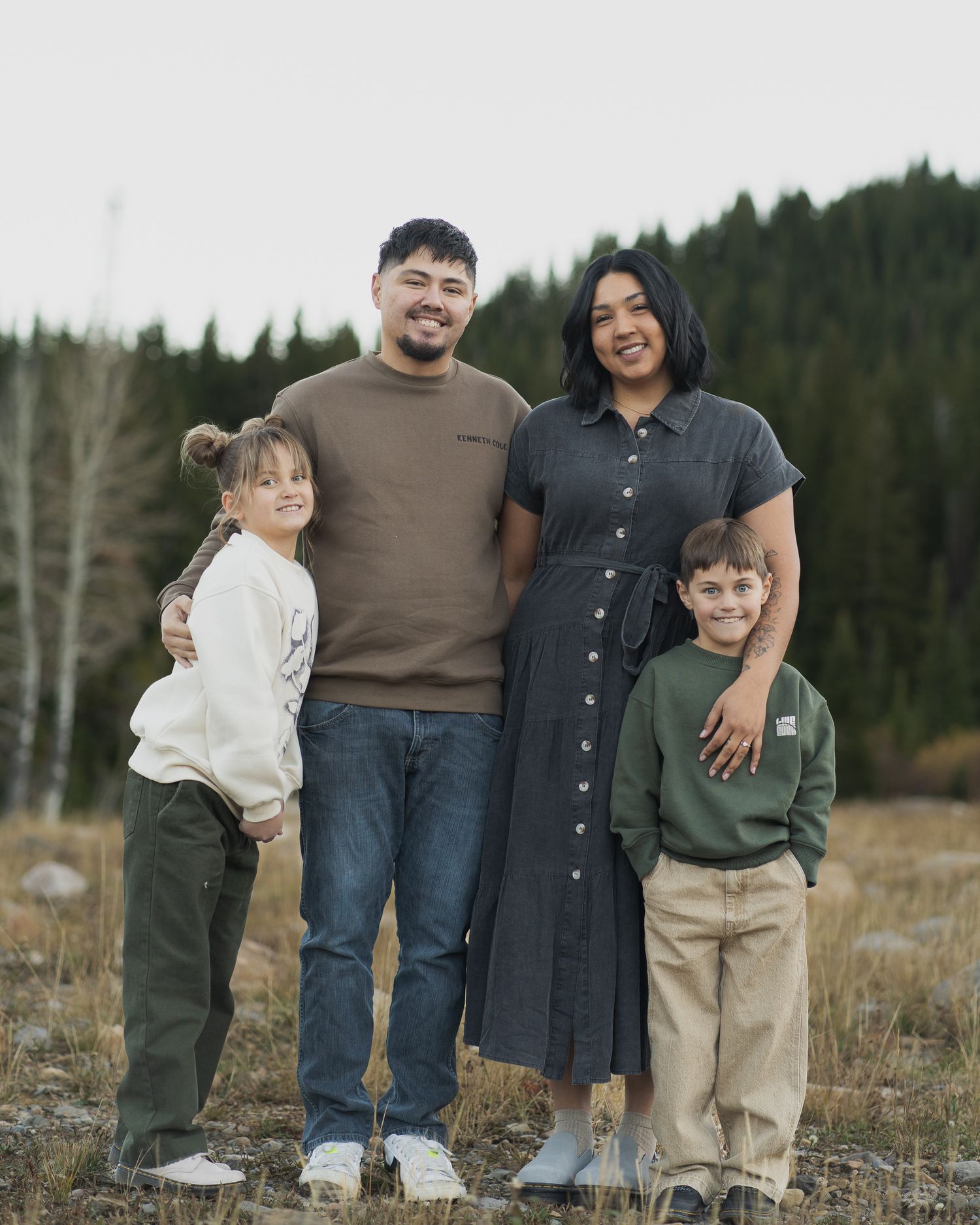 Family embracing in scenic Tony's Grove, Bear Lake, UT, during a photo session in Logan Canyon.