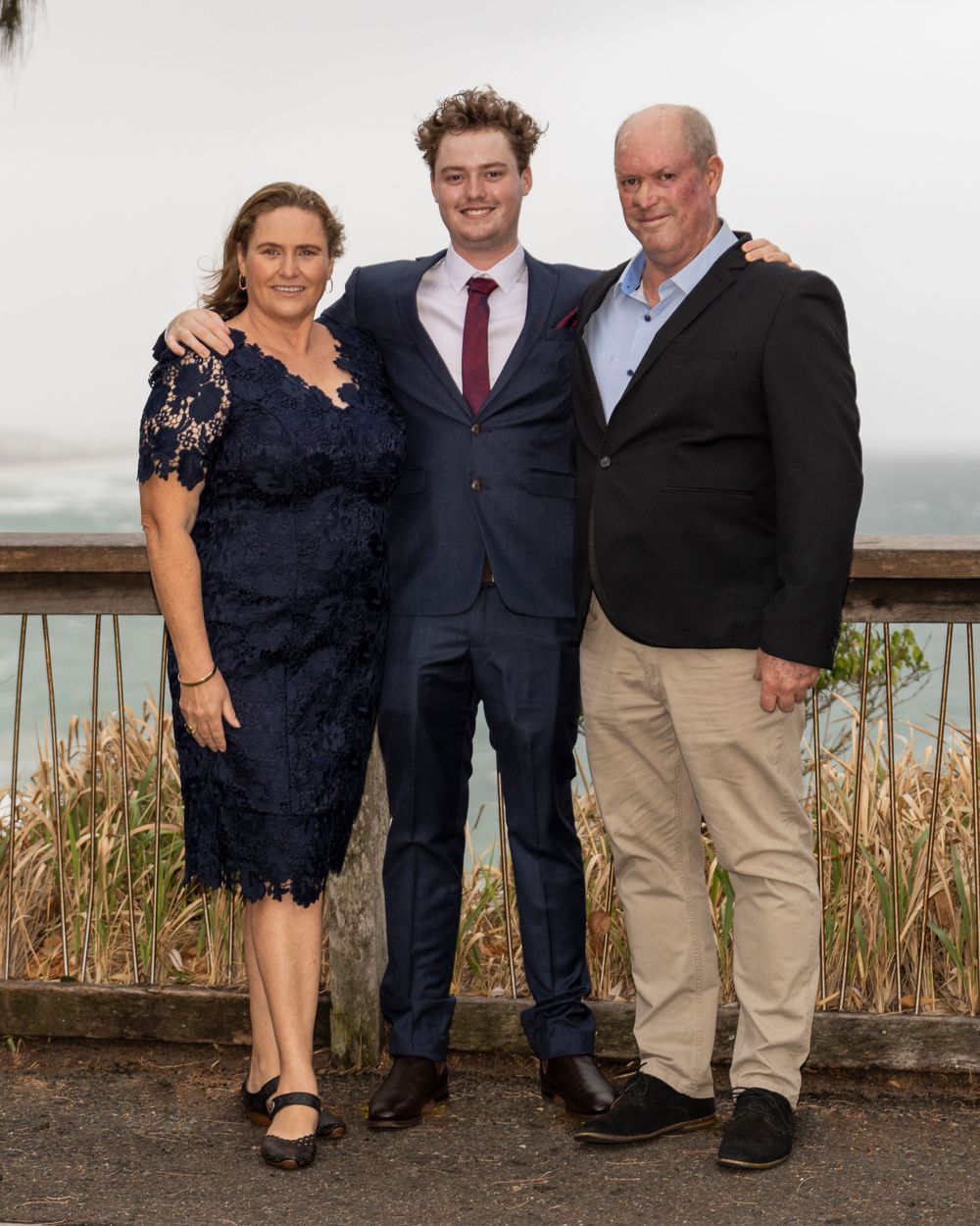 Year 12 formal photo of male on with his family captured by sunshine coast photographer